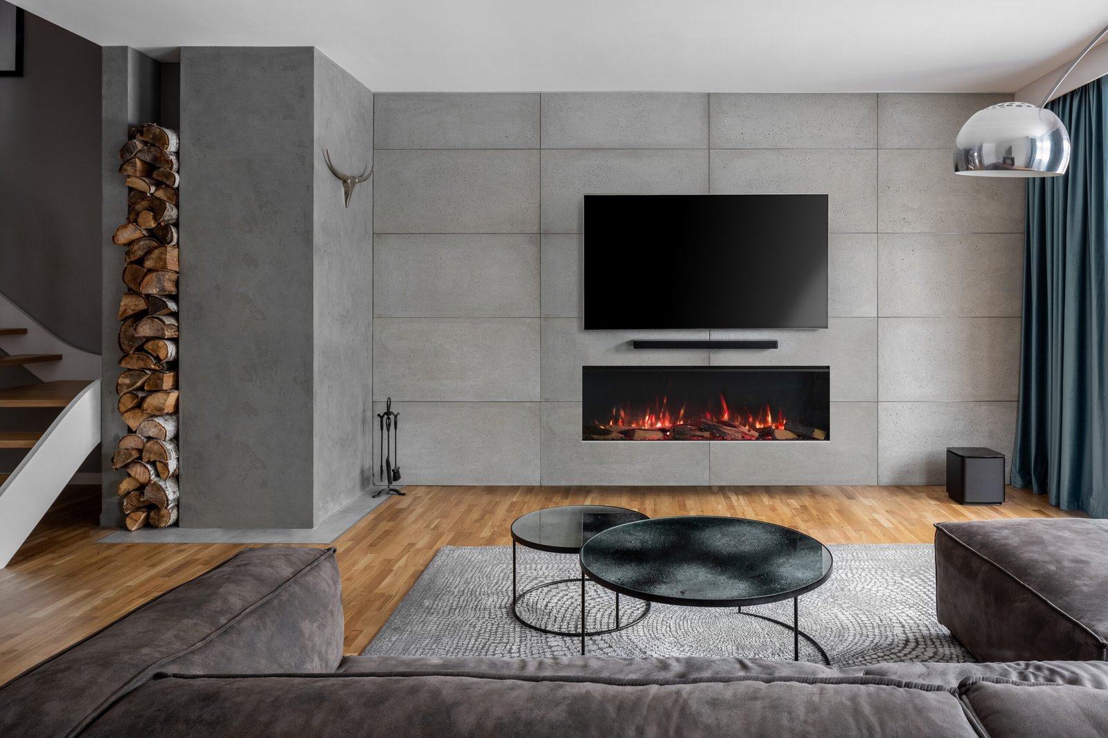 Tv living room with cement wall and wall mounted fireplace
