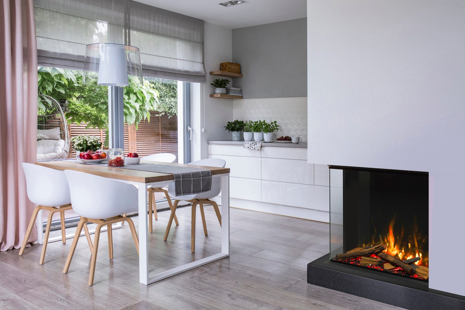 Real photo of a dining table, chairs and kitchen interior. Storage for fireplace wood. Empty wall, place for your poster
